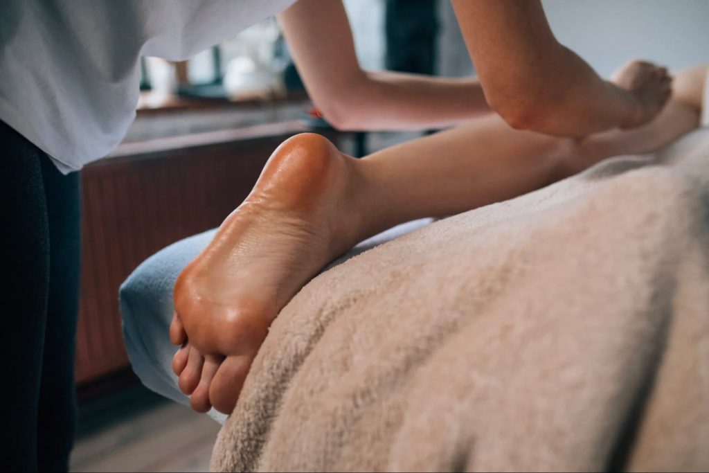 Foot reflexology massage therapy with the focus on pressure points in the feet to alleviate stress and improve overall health.